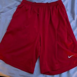 Red Nike basketball shorts. Size large